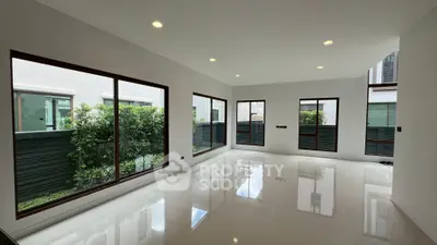 Spacious modern living room with large windows and garden view