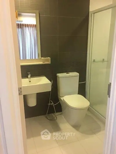 Modern bathroom with sleek fixtures and glass shower enclosure