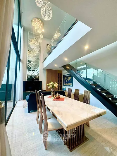 Luxurious modern living room with high ceilings and elegant dining area