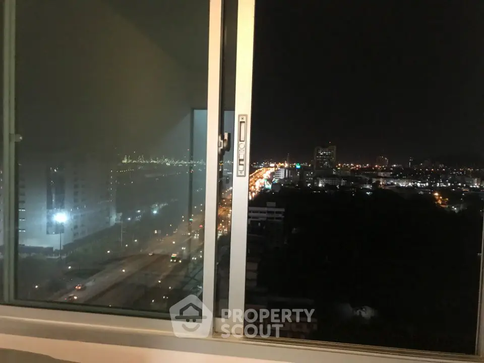 Stunning city night view from high-rise apartment window