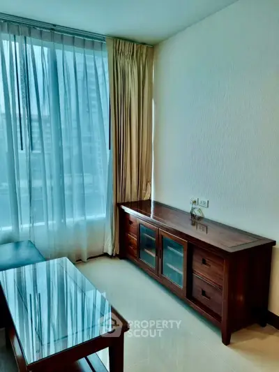 Elegant living room with wooden furniture and large window for natural light