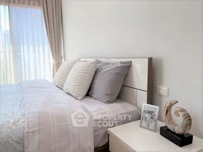 Elegant bedroom with stylish decor and natural light