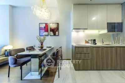 Modern kitchen and dining area with stylish decor and elegant lighting