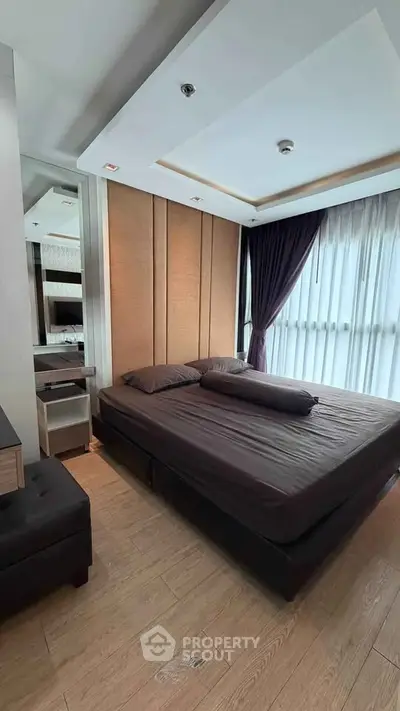 Modern bedroom with elegant design and large windows for natural light