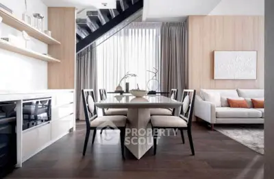 Modern open-plan living and dining area with elegant decor and natural light.