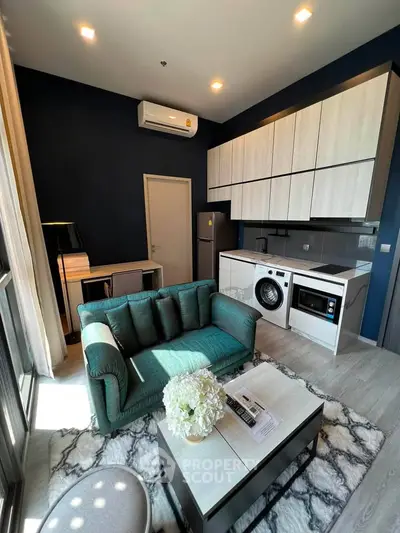 Modern living room with stylish furniture and integrated kitchen appliances in a cozy apartment.