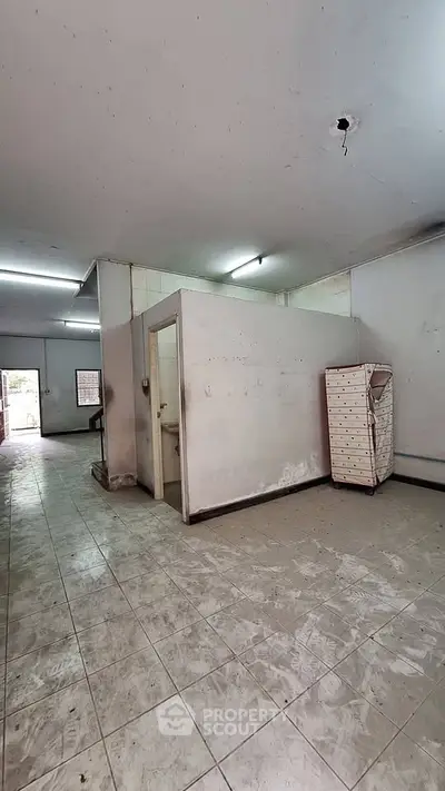 Spacious interior with tiled flooring and potential for renovation