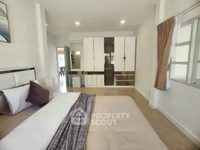 Spacious bedroom with modern decor and ample natural light