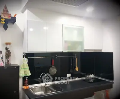Modern kitchen with sleek black countertops and white cabinets