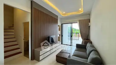 Modern living room with sleek design and large balcony access
