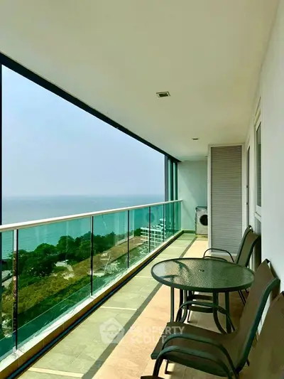 Spacious balcony with ocean view in modern high-rise apartment