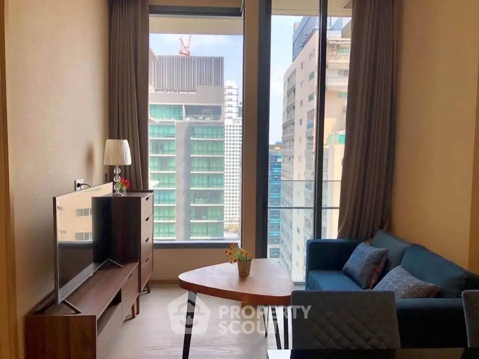 Modern living room with large windows offering city views, stylish furniture, and natural light.