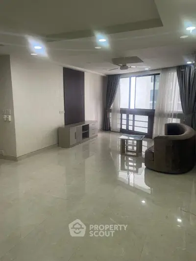 Spacious modern living room with elegant furnishings and large windows