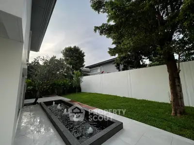 Modern backyard with sleek water feature and lush greenery