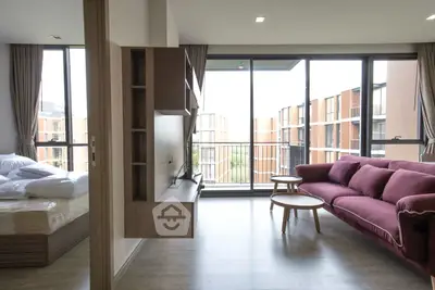 Modern living room with large windows and stylish furniture in a contemporary apartment.