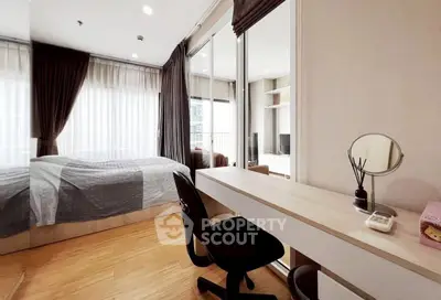 Modern bedroom with study area and large windows in a stylish apartment.