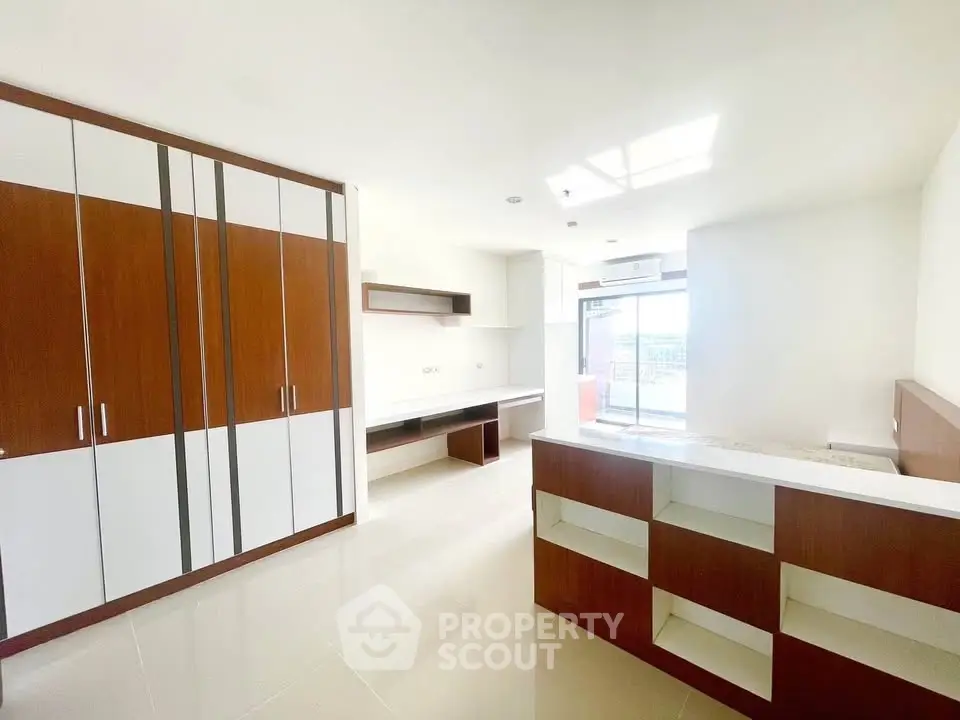 Spacious modern living room with built-in storage and large windows