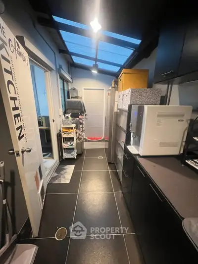 Modern kitchen with sleek black cabinets and skylight ceiling