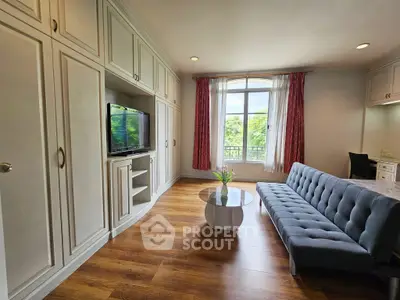 Spacious living room with elegant wood flooring and natural light