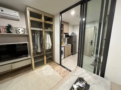 Modern apartment interior with open layout, featuring a cozy living area and sleek kitchen.