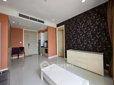 Modern living room with stylish wallpaper and sleek furniture in a contemporary apartment.