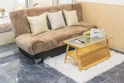 Cozy living room with plush sofa and stylish coffee table on marble floor