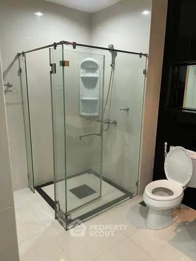 Modern bathroom with glass shower enclosure and sleek fixtures