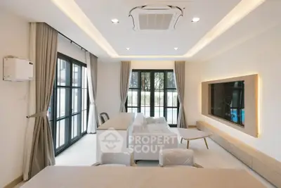 Modern living room with large windows and stylish furniture