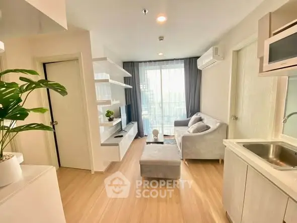 Modern living room with sleek design and natural light, featuring cozy seating and stylish decor.