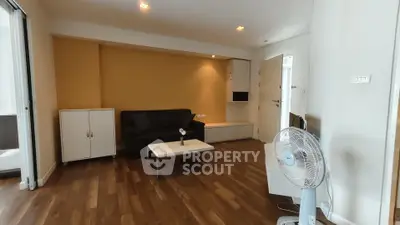 Spacious living room with modern decor and wooden flooring