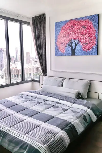 Modern bedroom with city view and stylish decor in high-rise apartment