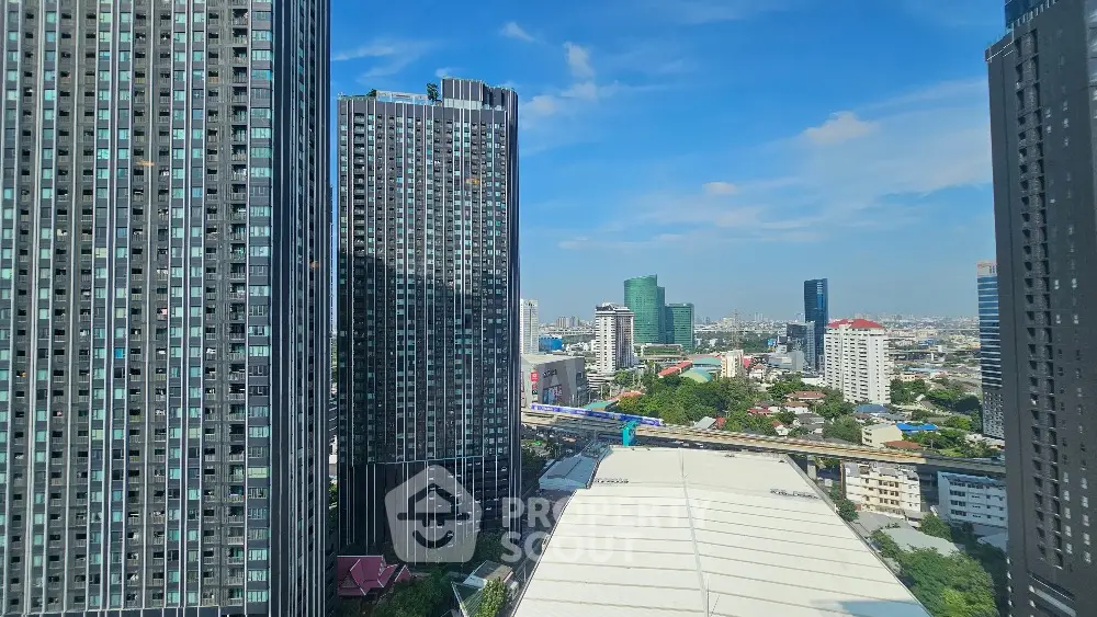 Stunning cityscape view with modern high-rise buildings and clear blue sky.