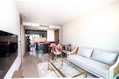Modern living room with stylish furniture and open kitchen layout