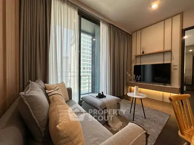 Modern living room with cozy sofa, stylish decor, and large window offering city view.