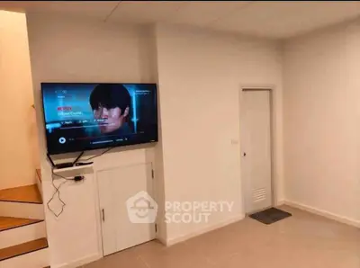 Modern living room with wall-mounted TV and minimalist design