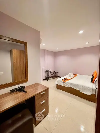 Cozy bedroom with modern furniture and soft lighting, perfect for relaxation and comfort.