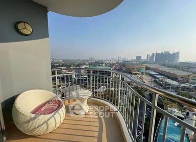 Stunning balcony with panoramic city view and modern outdoor seating.