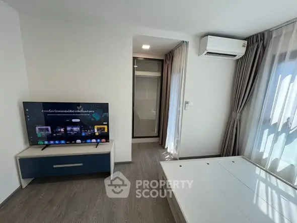 Modern living room with sleek TV setup and natural light