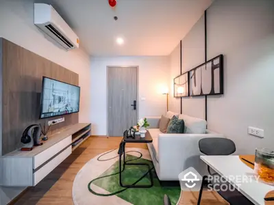 Modern living room with stylish decor and wall-mounted TV in a cozy apartment setting.