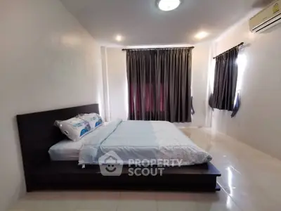 Spacious bedroom with elegant curtains and modern bed setup