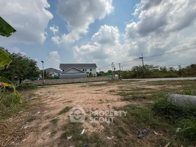 Spacious land plot with potential for development under a clear blue sky.
