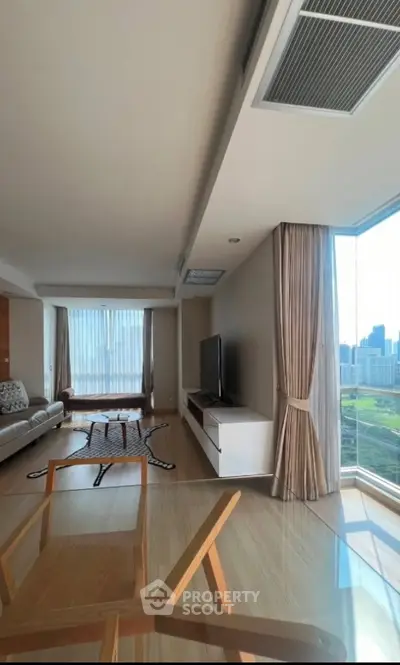 Spacious modern living room with panoramic city view and elegant decor