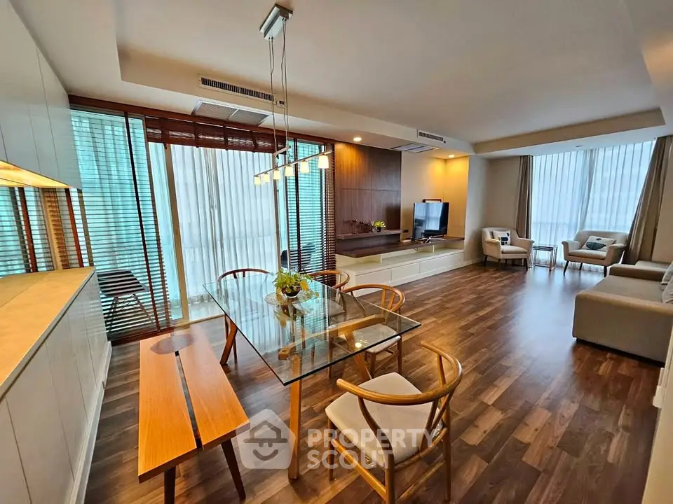 Spacious modern living room with elegant wooden flooring and stylish furniture