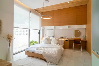 Modern bedroom with wooden accents and large window, featuring a cozy bed and stylish decor.