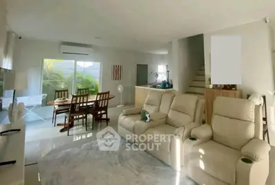 Spacious living room with modern furniture and dining area, perfect for family gatherings.