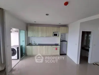 Modern kitchen with sleek cabinetry and integrated appliances in open layout