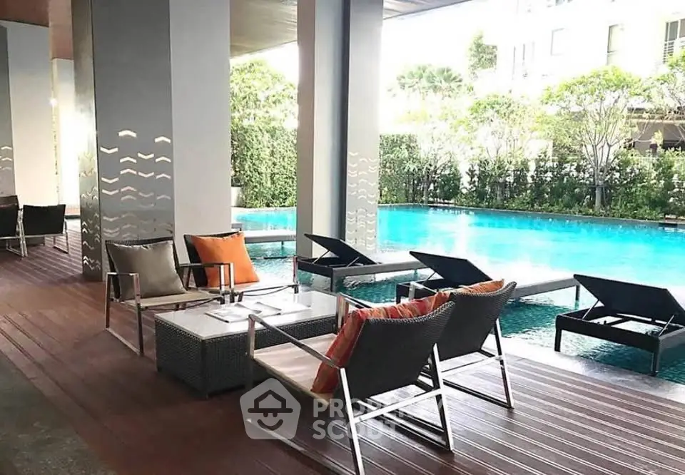 Luxurious poolside area with modern seating and lush greenery