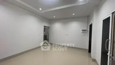 Spacious empty room with modern lighting and glossy tiled floor, ideal for customization.