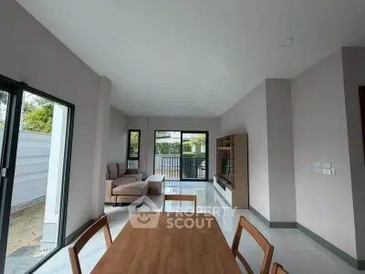 Spacious modern living room with large windows and stylish furniture