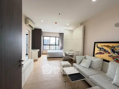 Modern studio apartment with city view, featuring cozy living area and stylish decor.